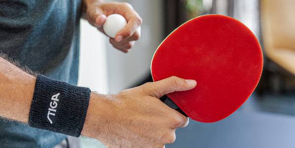 Holding a ping pong paddle